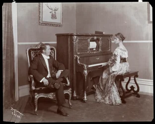 Man and woman playing a player piano, New York, 1907